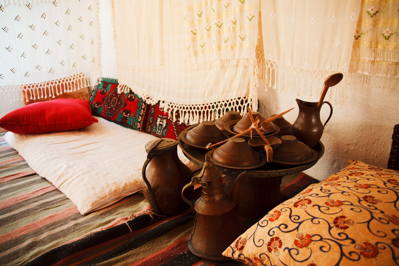 Ein nachgestelltes historisches Wohnzimmer im Ibrahim-Pascha-Palast mit traditionellen Teppichen und Kupferwaren.
