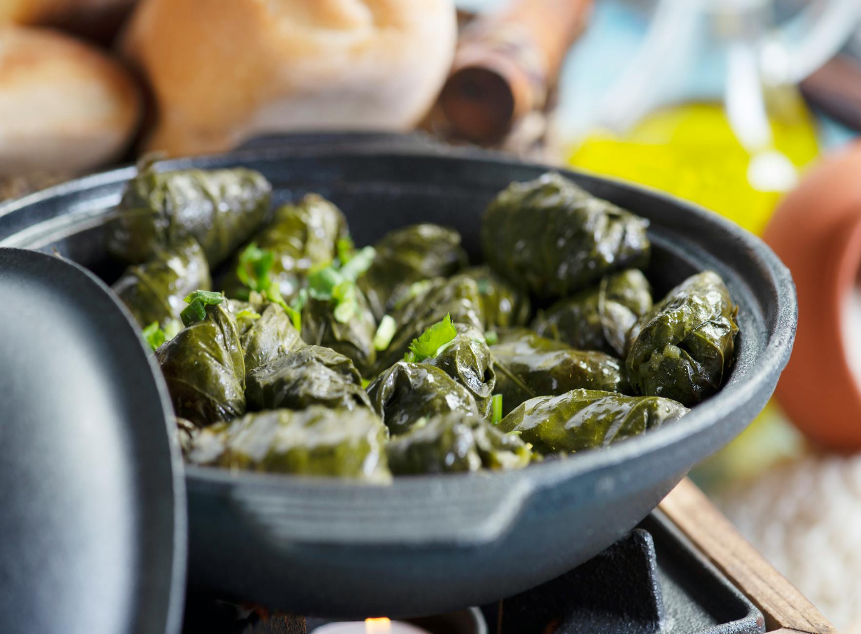 Nahaufnahme von Sarma, gefüllte Weinblätter, in einer dunklen Pfanne, typisches türkisches Street Food.